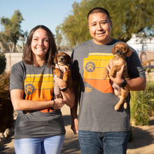 Load image into Gallery viewer, Female wearing grey Arizona Humane Society t-shirt holding puppy, with male wearing grey Arizona Humane Society t-shirt holding puppy
